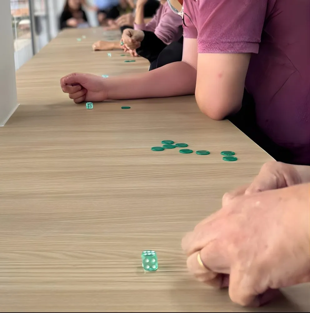 Participants playing a supply-chain simulation with chips and dice